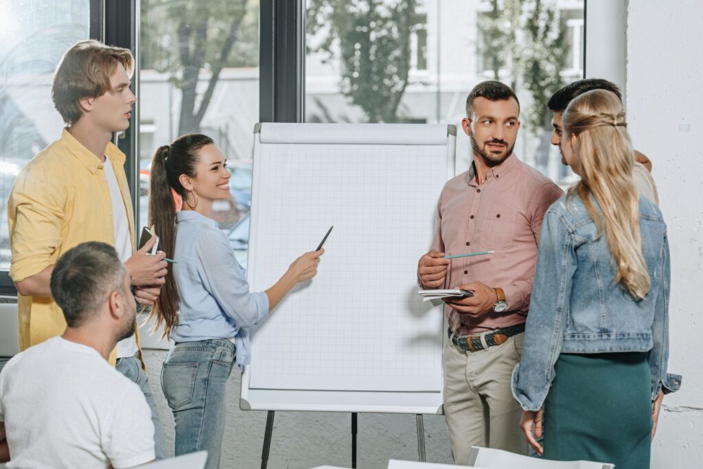 young-businesspeople-standing-near-flipchart-in-of-2023-11-27-05-10-28-utc_1618x1080-q80